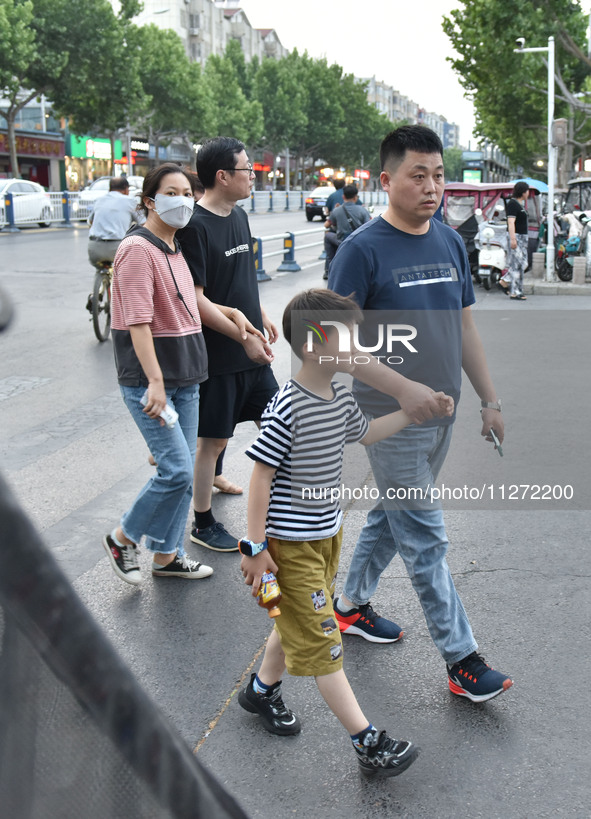 Citizens are walking on a street in Fuyang, Anhui province, China, on May 25, 2024. The World Health Organization (WHO) is releasing its ann...