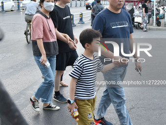 Citizens are walking on a street in Fuyang, Anhui province, China, on May 25, 2024. The World Health Organization (WHO) is releasing its ann...