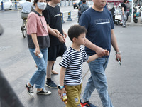 Citizens are walking on a street in Fuyang, Anhui province, China, on May 25, 2024. The World Health Organization (WHO) is releasing its ann...