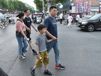 Citizens are walking on a street in Fuyang, Anhui province, China, on May 25, 2024. The World Health Organization (WHO) is releasing its ann...