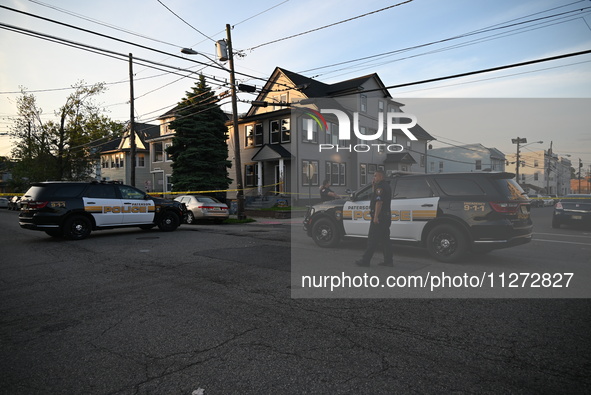 Police officers are blocking the area of the crime scene on Saturday morning. Three people are being shot in Paterson, New Jersey, United St...