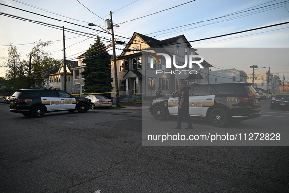 Police officers are blocking the area of the crime scene on Saturday morning. Three people are being shot in Paterson, New Jersey, United St...