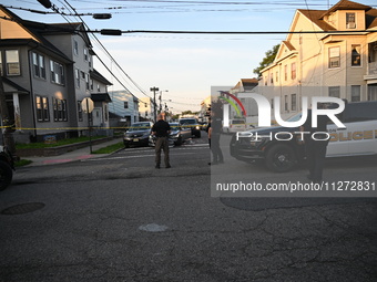 Police officers are blocking the area of the crime scene on Saturday morning. Three people are being shot in Paterson, New Jersey, United St...