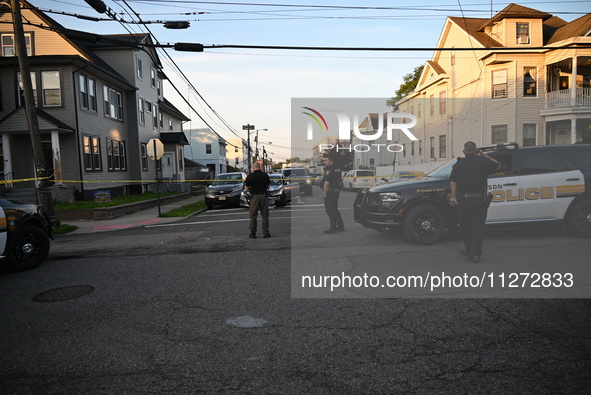 Police officers are blocking the area of the crime scene on Saturday morning. Three people are being shot in Paterson, New Jersey, United St...