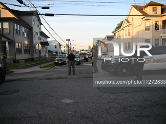 Police officers are blocking the area of the crime scene on Saturday morning. Three people are being shot in Paterson, New Jersey, United St...