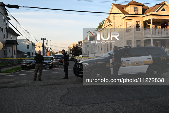 Police officers are blocking the area of the crime scene on Saturday morning. Three people are being shot in Paterson, New Jersey, United St...