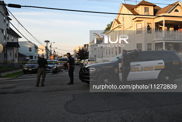 Police officers are blocking the area of the crime scene on Saturday morning. Three people are being shot in Paterson, New Jersey, United St...