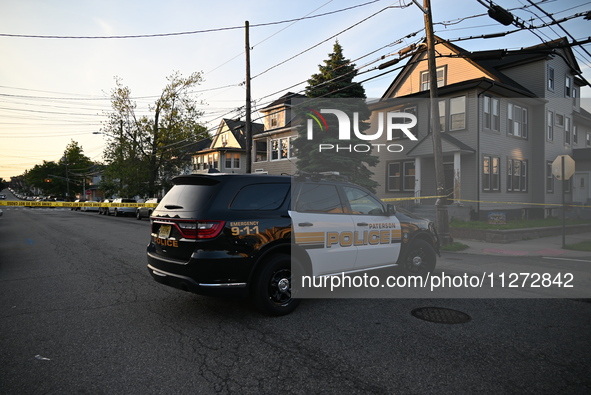 Police officers are blocking the area of the crime scene on Saturday morning. Three people are being shot in Paterson, New Jersey, United St...