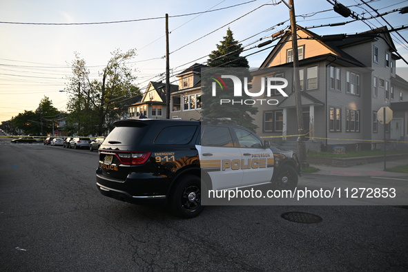 Police officers are blocking the area of the crime scene on Saturday morning. Three people are being shot in Paterson, New Jersey, United St...