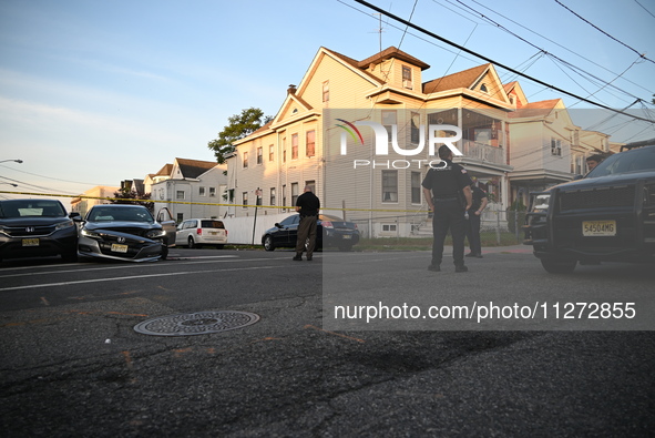 Police officers are blocking the area of the crime scene on Saturday morning. Three people are being shot in Paterson, New Jersey, United St...