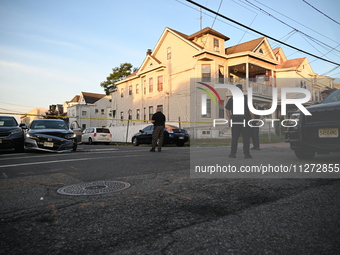 Police officers are blocking the area of the crime scene on Saturday morning. Three people are being shot in Paterson, New Jersey, United St...