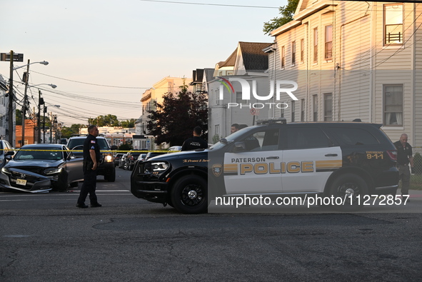 Police officers are blocking the area of the crime scene on Saturday morning. Three people are being shot in Paterson, New Jersey, United St...