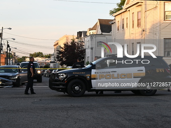 Police officers are blocking the area of the crime scene on Saturday morning. Three people are being shot in Paterson, New Jersey, United St...