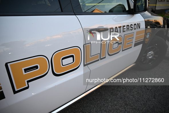 The Paterson police logo is on a police vehicle at the crime scene in Paterson, New Jersey, United States, on May 25, 2024. At approximately...