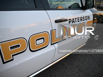 The Paterson police logo is on a police vehicle at the crime scene in Paterson, New Jersey, United States, on May 25, 2024. At approximately...