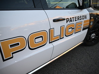 The Paterson police logo is on a police vehicle at the crime scene in Paterson, New Jersey, United States, on May 25, 2024. At approximately...