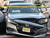 A vehicle is being damaged from bullet holes in the windshield at the crime scene on Saturday morning. Three people are being shot in Paters...