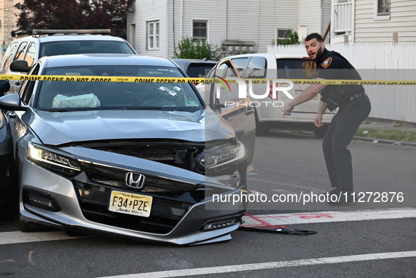 A vehicle is being damaged from bullet holes in the windshield at the crime scene on Saturday morning. Three people are being shot in Paters...