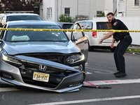 A vehicle is being damaged from bullet holes in the windshield at the crime scene on Saturday morning. Three people are being shot in Paters...