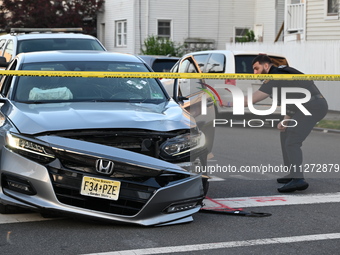 A vehicle is being damaged from bullet holes in the windshield at the crime scene on Saturday morning. Three people are being shot in Paters...