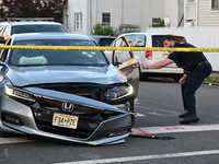 A vehicle is being damaged from bullet holes in the windshield at the crime scene on Saturday morning. Three people are being shot in Paters...