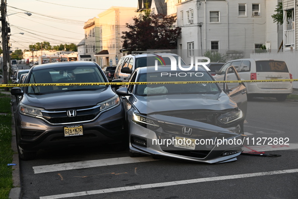 A vehicle is being damaged from bullet holes in the windshield at the crime scene on Saturday morning. Three people are being shot in Paters...