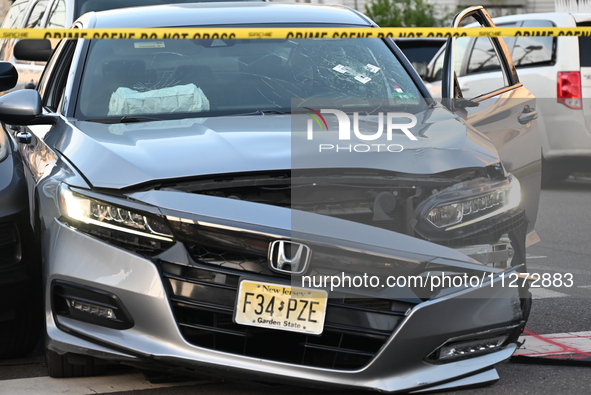 A vehicle is being damaged from bullet holes in the windshield at the crime scene on Saturday morning. Three people are being shot in Paters...