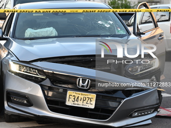 A vehicle is being damaged from bullet holes in the windshield at the crime scene on Saturday morning. Three people are being shot in Paters...