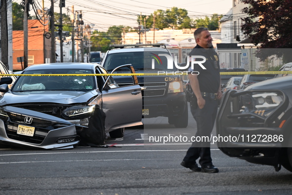 A vehicle is being damaged from bullet holes in the windshield at the crime scene on Saturday morning. Three people are being shot in Paters...