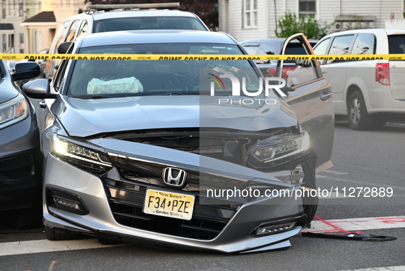 A vehicle is being damaged from bullet holes in the windshield at the crime scene on Saturday morning. Three people are being shot in Paters...