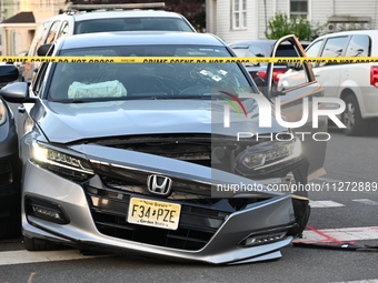 A vehicle is being damaged from bullet holes in the windshield at the crime scene on Saturday morning. Three people are being shot in Paters...