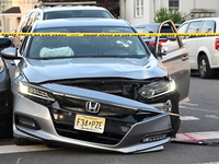 A vehicle is being damaged from bullet holes in the windshield at the crime scene on Saturday morning. Three people are being shot in Paters...