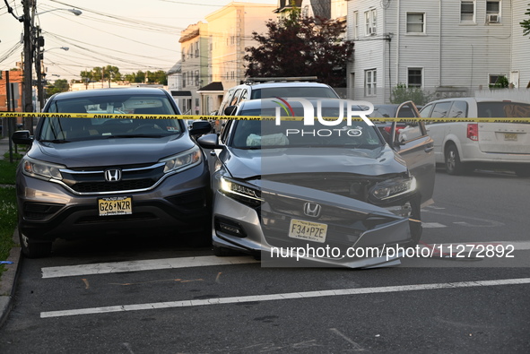 A vehicle is being damaged from bullet holes in the windshield at the crime scene on Saturday morning. Three people are being shot in Paters...