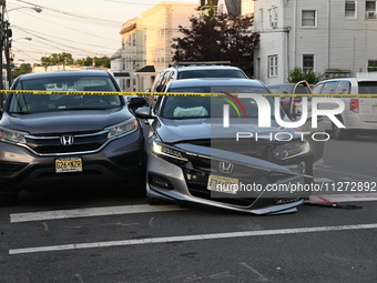 A vehicle is being damaged from bullet holes in the windshield at the crime scene on Saturday morning. Three people are being shot in Paters...