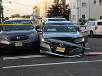 A vehicle is being damaged from bullet holes in the windshield at the crime scene on Saturday morning. Three people are being shot in Paters...