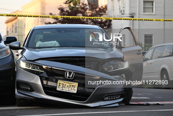 A vehicle is being damaged from bullet holes in the windshield at the crime scene on Saturday morning. Three people are being shot in Paters...