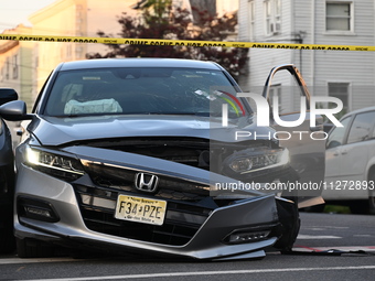 A vehicle is being damaged from bullet holes in the windshield at the crime scene on Saturday morning. Three people are being shot in Paters...