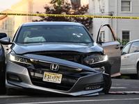 A vehicle is being damaged from bullet holes in the windshield at the crime scene on Saturday morning. Three people are being shot in Paters...