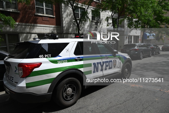 An NYPD police vehicle is at the crime scene. An unidentified male victim is being killed after being stabbed multiple times inside an apart...