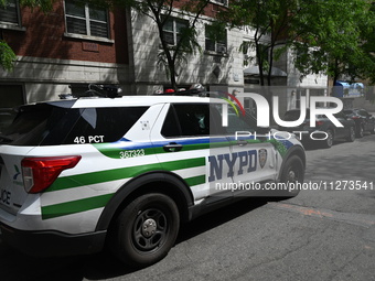 An NYPD police vehicle is at the crime scene. An unidentified male victim is being killed after being stabbed multiple times inside an apart...