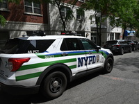 An NYPD police vehicle is at the crime scene. An unidentified male victim is being killed after being stabbed multiple times inside an apart...