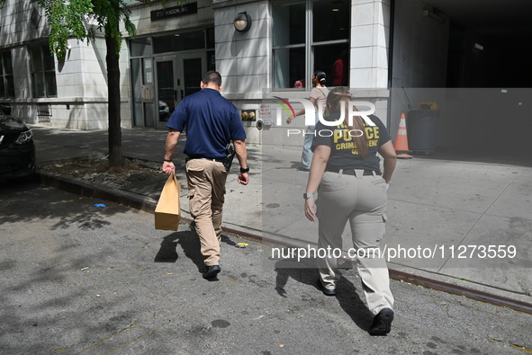 NYPD crime scene unit investigators are collecting evidence at the apartment building where the fatal stabbing took place. An unidentified m...