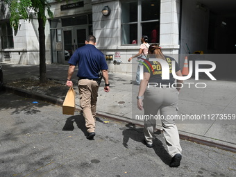 NYPD crime scene unit investigators are collecting evidence at the apartment building where the fatal stabbing took place. An unidentified m...