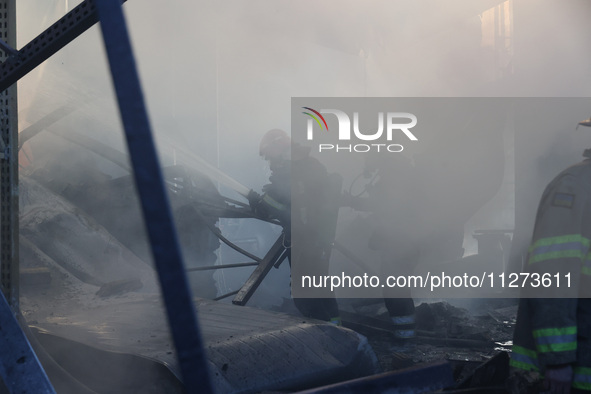 Rescuers are responding to a Russian glide bomb attack on an Epicentr K construction supermarket in Kharkiv, Ukraine, on May 25, 2024. At le...