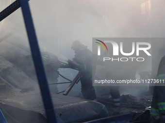 Rescuers are responding to a Russian glide bomb attack on an Epicentr K construction supermarket in Kharkiv, Ukraine, on May 25, 2024. At le...