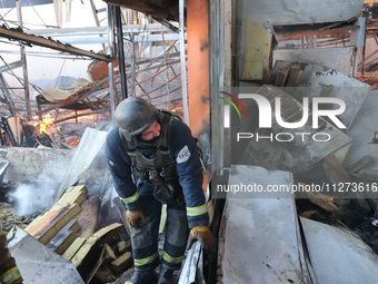 A rescuer is responding to a Russian glide bomb attack on an Epicentr K construction supermarket in Kharkiv, Ukraine, on May 25, 2024. At le...