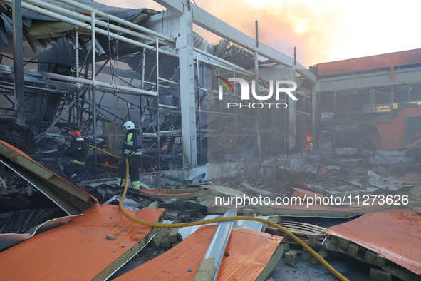 Rescuers are responding to a Russian glide bomb attack on an Epicentr K construction supermarket in Kharkiv, Ukraine, on May 25, 2024. At le...