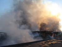 Smoke is rising over an Epicentr K construction supermarket hit with two Russian glide bombs in Kharkiv, Ukraine, on May 25, 2024. At least...