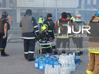 Rescuers are gathering outside an Epicentr K construction supermarket hit with two Russian glide bombs in Kharkiv, Ukraine, on May 25, 2024....