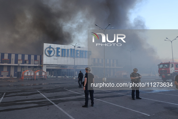 Law enforcers are staying outside an Epicentr K construction supermarket hit with two Russian glide bombs in Kharkiv, Ukraine, on May 25, 20...